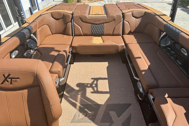 Slide: The Image of 2026 MasterCraft XT24 boat interior with luxurious brown leather seating and modern design. - 7