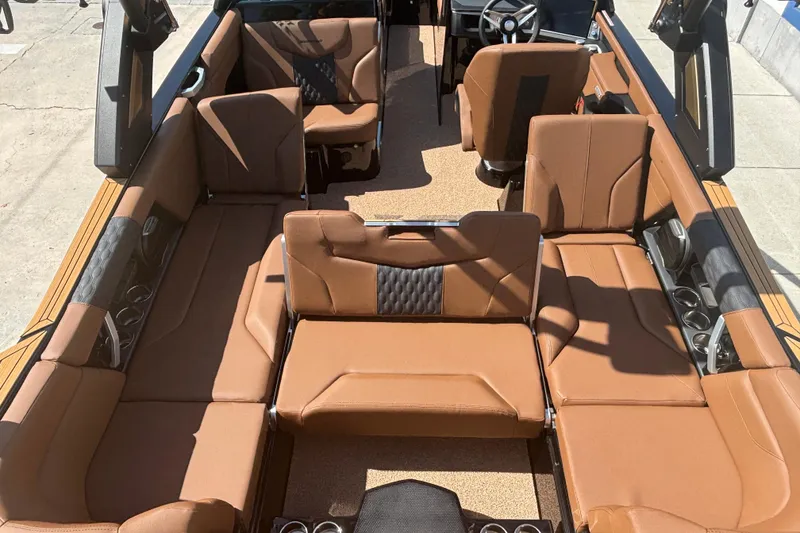 Slide: The Image of 2026 MasterCraft XT24 boat interior with brown leather seating and modern design. - 8
