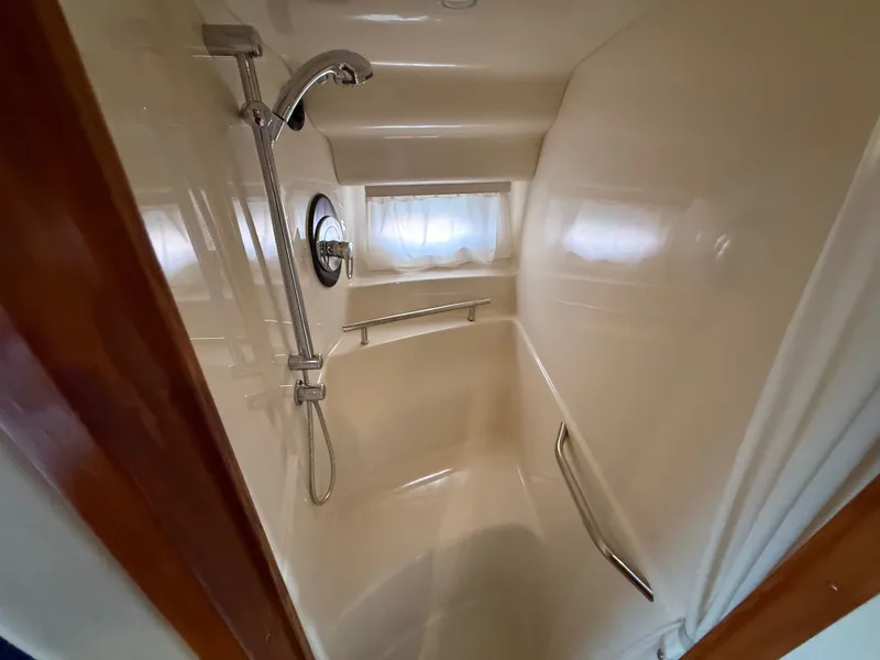 Slide: The Image of Shower area in 2004 Sea Ray 390 Sundancer yacht, featuring sleek design and modern fixtures. - 14