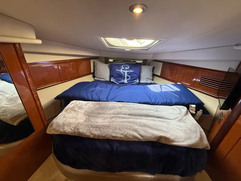 Slide: The Image of Luxurious cabin interior of 2004 Sea Ray 390 Sundancer yacht with cozy bedding. - 15