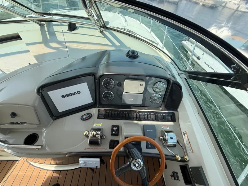 Slide: The Image of Helm of 2004 Sea Ray 390 Sundancer with Simrad navigation system and wooden steering wheel. - 6