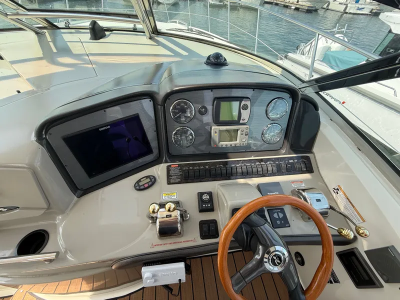 Slide: The Image of Helm of 2004 Sea Ray 390 Sundancer with navigation instruments and wooden steering wheel. - 7
