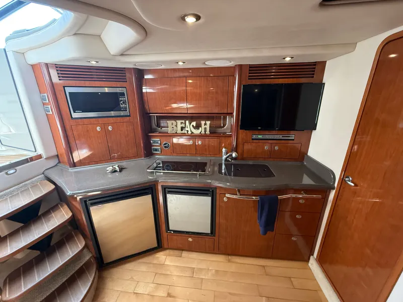 Slide: The Image of Luxurious 2004 Sea Ray 390 Sundancer yacht interior with modern kitchen amenities. - 9