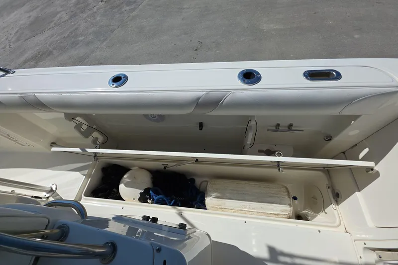 Slide: The Image of 2006 Boston Whaler 240 Outrage boat storage compartment with equipment and accessories. - 11