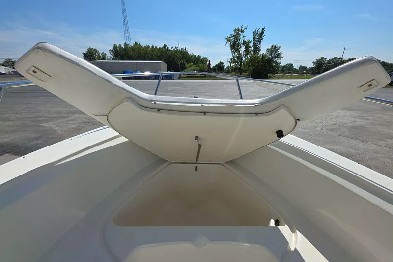 Slide: The Image of 2006 Boston Whaler 240 Outrage boat with open storage compartment, outdoor setting. - 12