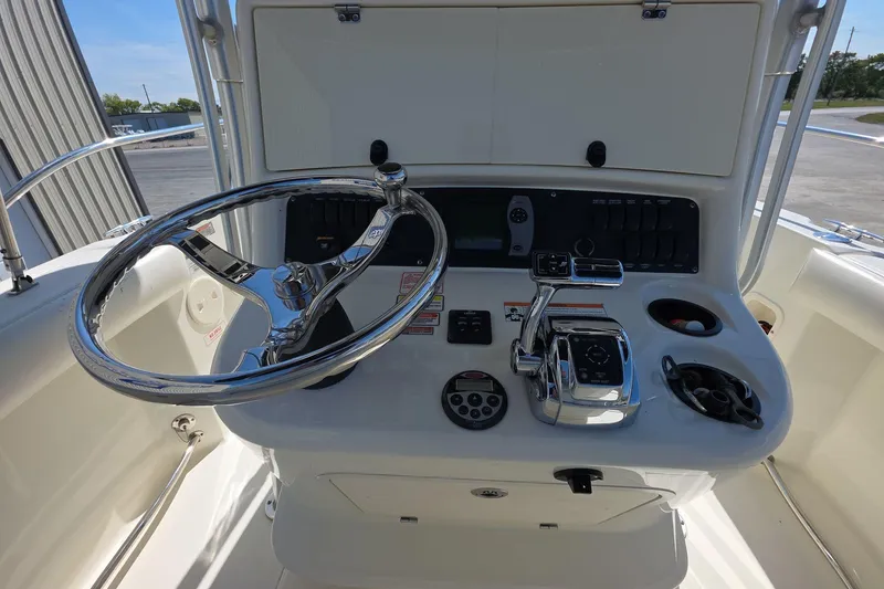 Slide: The Image of 2006 Boston Whaler 240 Outrage boat console with steering wheel and controls. - 14