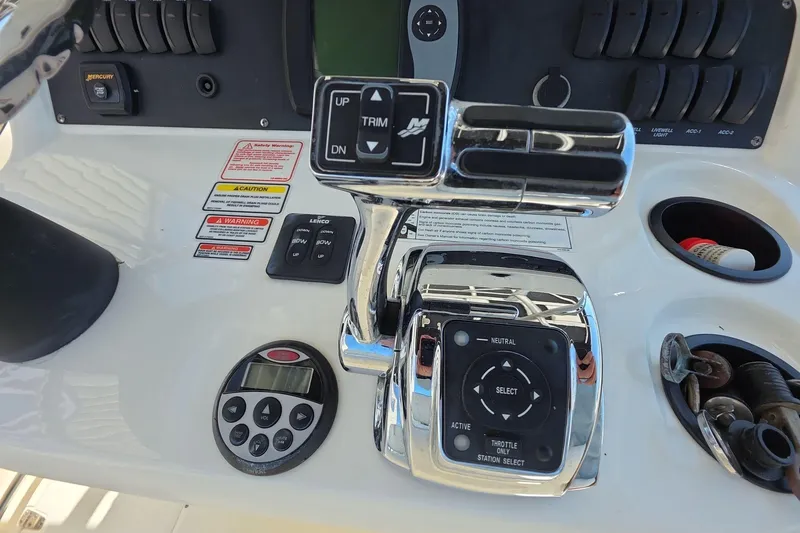 Slide: The Image of Control panel of a 2006 Boston Whaler 240 Outrage boat with throttle and trim controls. - 15