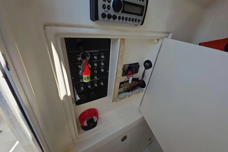Slide: The Image of Electrical panel and stereo system inside a 2006 Boston Whaler 240 Outrage boat. - 19
