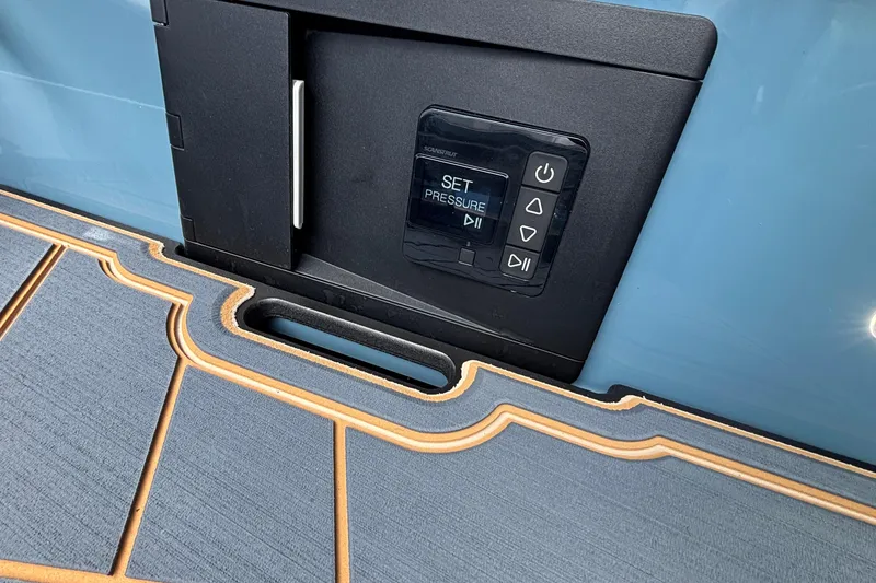 Slide: The Image of Control panel on 2026 Tigé Ultré 25ZX boat with blue and tan deck. - 21