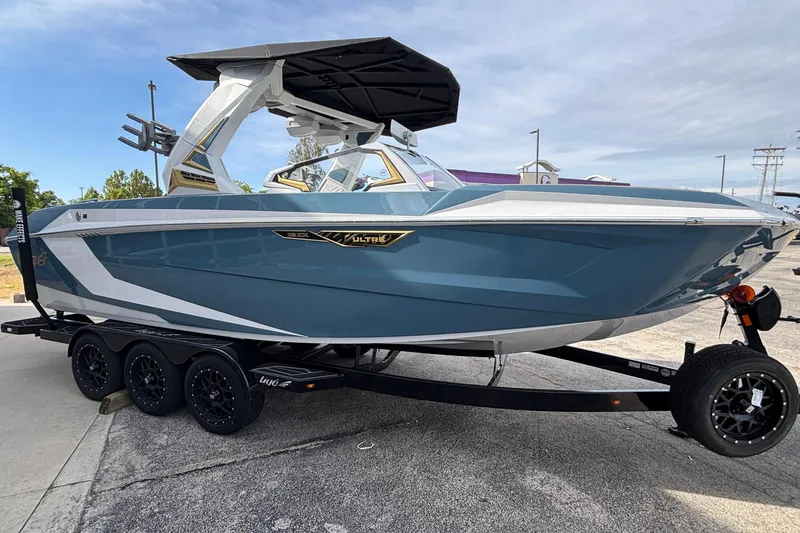 Slide: The Image of 2026 Tigé Ultré 25ZX boat on trailer, sleek blue and white design. - 3