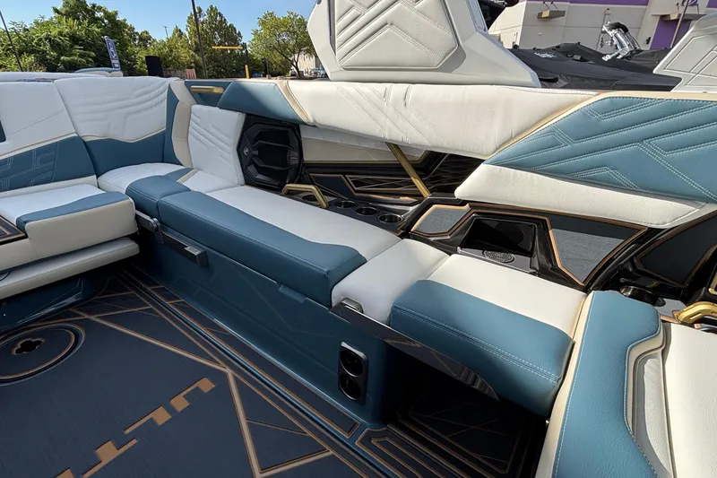 Slide: The Image of Luxurious interior of 2026 Tigé Ultré 25ZX boat with blue and white seating. - 31