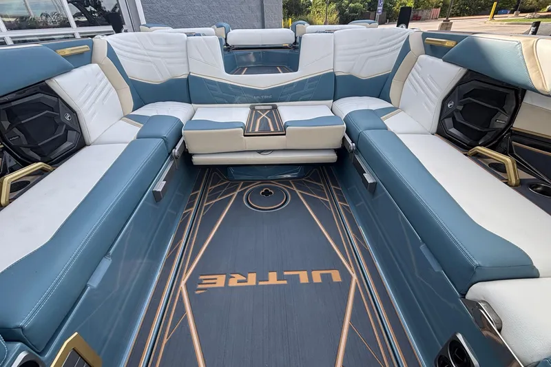 Slide: The Image of 2026 Tigé Ultré 25ZX boat interior with luxurious blue and white seating. - 32