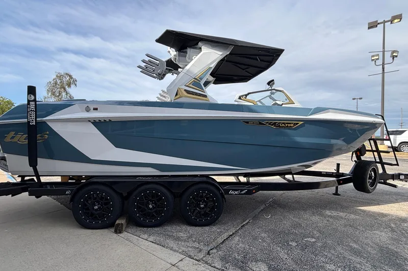 Slide: The Image of 2026 Tigé Ultré 25ZX boat on trailer, sleek design, blue and white color scheme. - 4