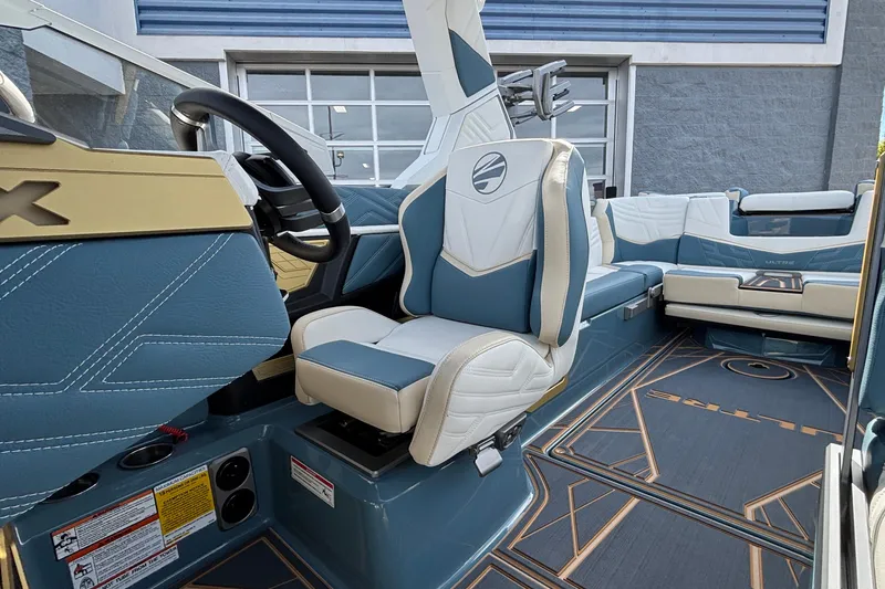 Slide: The Image of 2026 Tigé Ultré 25ZX boat interior with blue and white seating, modern design. - 44