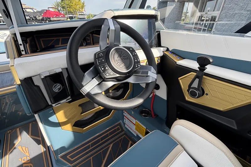 Slide: The Image of 2026 Tigé Ultré 25ZX boat interior with modern steering wheel and control panel. - 47