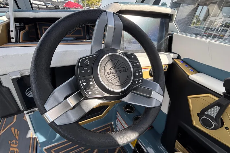 Slide: The Image of Steering wheel of 2026 Tigé Ultré 25ZX boat with control buttons. - 48