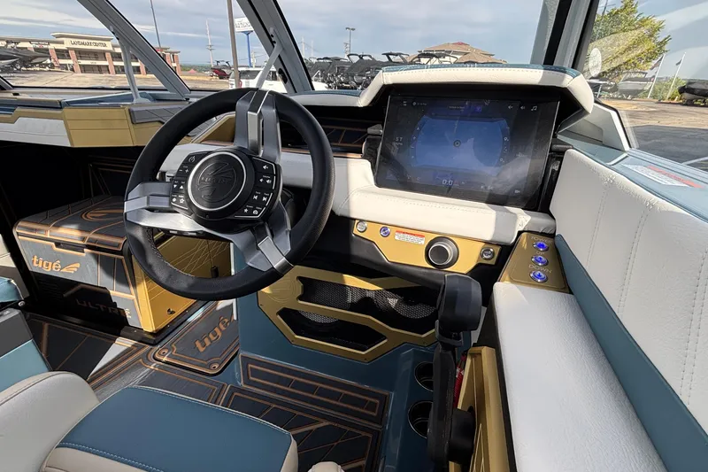 Slide: The Image of 2026 Tigé Ultré 25ZX boat interior with modern steering wheel and touchscreen display. - 49