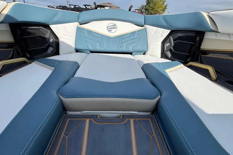 Slide: The Image of 2026 Tigé Ultré 25ZX boat interior with blue and white seating, modern design. - 53