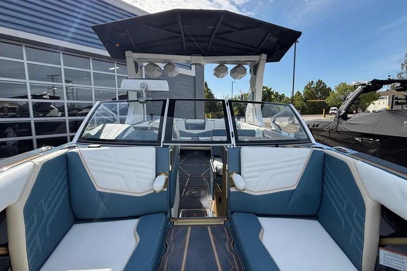 Slide: The Image of 2026 Tigé Ultré 25ZX boat interior with blue and white seating, modern design. - 55