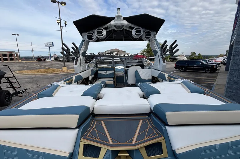 Slide: The Image of 2026 Tigé Ultré 25ZX boat with luxurious seating and modern design in a parking lot. - 6