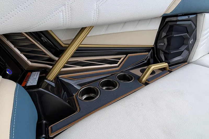 Slide: The Image of 2026 Tigé Ultré 25ZX interior detail with cup holders and speaker system. - 62