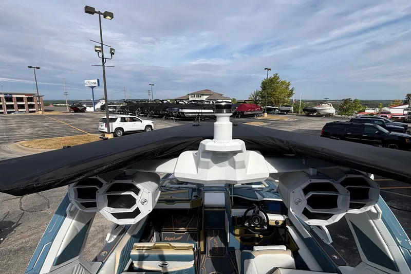 Slide: The Image of 2026 Tigé Ultré 25ZX boat with advanced audio system and sleek design in a parking lot. - 66