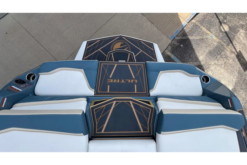 Slide: The Image of 2026 Tigé Ultré 25ZX boat interior with blue and white seating, geometric design. - 67