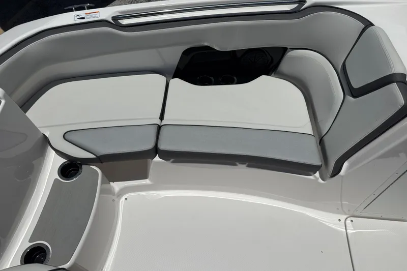 Slide: The Image of 2025 Yamaha Boats AR250 interior seating with gray and white upholstery. - 10