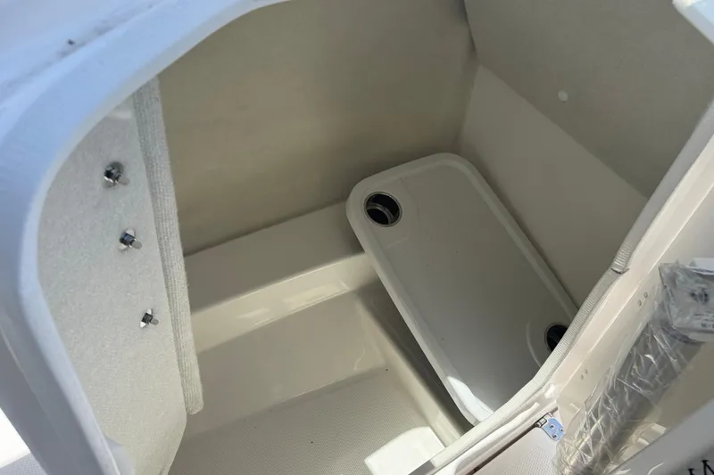 Slide: The Image of 2025 Yamaha AR250 boat storage compartment interior with drain. - 15