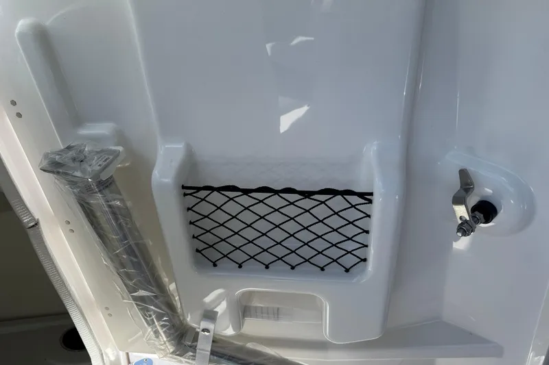 Slide: The Image of 2025 Yamaha Boats AR250 interior detail with storage net and hardware. - 16