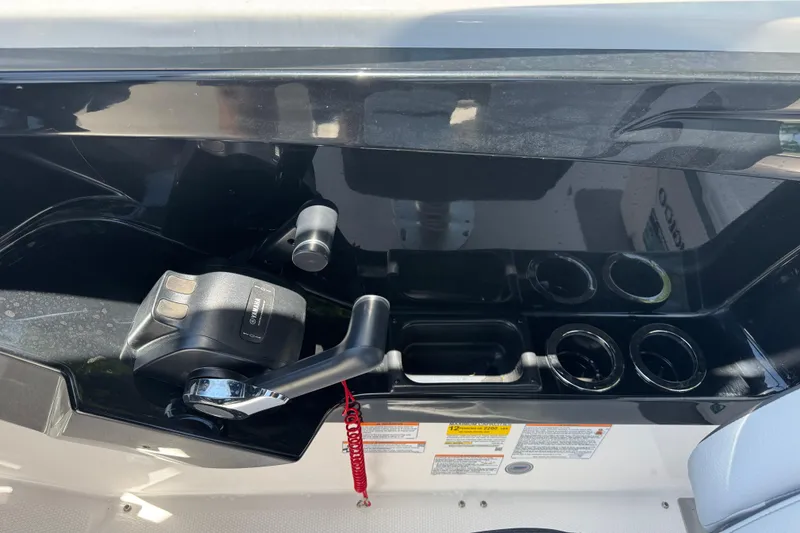 Slide: The Image of 2025 Yamaha Boats AR250 control panel with throttle and cup holders. - 21