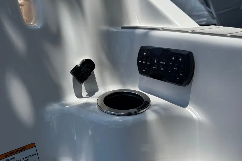 Slide: The Image of 2025 Yamaha AR250 boat control panel with cup holder and audio controls. - 29