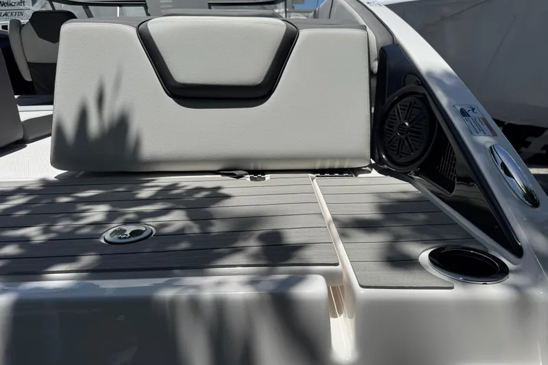 Slide: The Image of 2025 Yamaha Boats AR250 deck with seating, speaker, and cup holder in sunlight. - 30