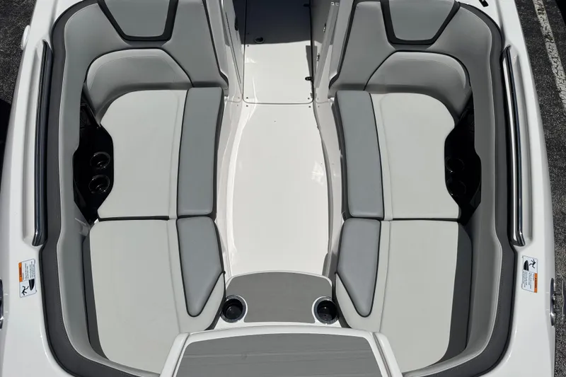 Slide: The Image of 2025 Yamaha Boats AR250 interior seating, featuring sleek gray and white upholstery. - 7