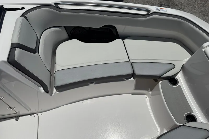 Slide: The Image of 2025 Yamaha Boats AR250 interior seating with gray and white upholstery. - 8