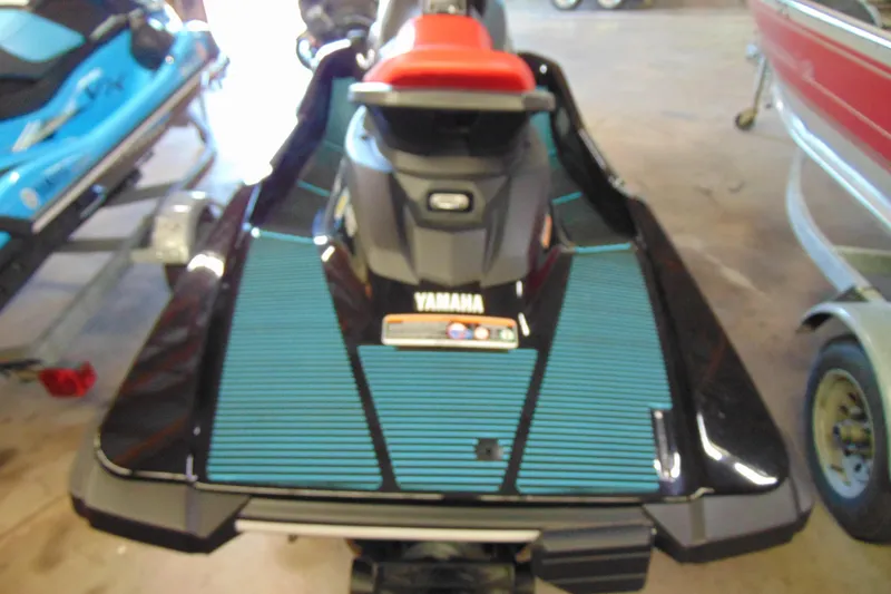 Slide: The Image of 2024 Yamaha WaveRunner EX Sport, black and blue, in a showroom setting. - 3