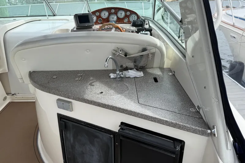 Slide: The Image of 2004 Rinker 342 boat interior with helm, sink, and control panel. - 12
