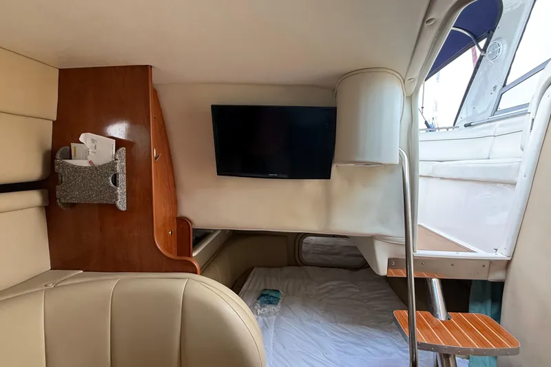 Slide: The Image of Interior cabin of a 2004 Rinker 342 boat with TV and seating area. - 5