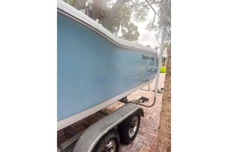 Slide: The Image of 2017 Tidewater 230 CC Adventure boat on trailer, parked on brick driveway. - 4