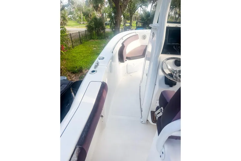 Slide: The Image of 2017 Tidewater 230 CC Adventure boat interior with seating and steering wheel. - 8