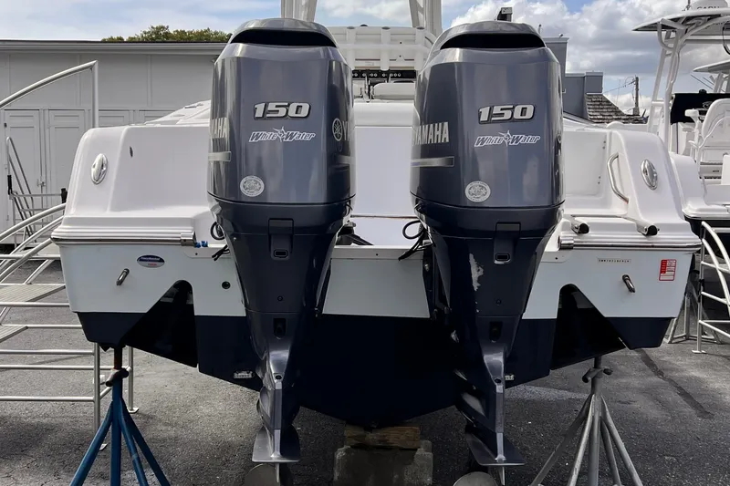 Slide: The Image of 2014 Sportsman Heritage 251 Center Console with twin Yamaha 150 outboard motors. - 2