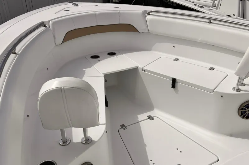 Slide: The Image of 2014 Sportsman Heritage 251 Center Console boat interior with white seating and storage compartments. - 3