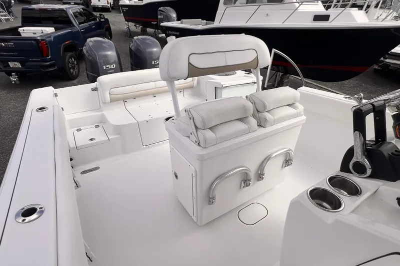Slide: The Image of 2014 Sportsman Heritage 251 Center Console boat interior with seating and dual engines. - 5