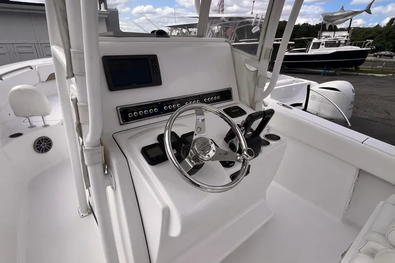 Slide: The Image of 2014 Sportsman Heritage 251 Center Console boat interior with steering wheel and controls. - 7