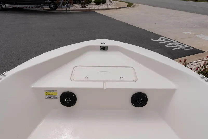 Slide: The Image of 2026 Carolina Skiff EV180 Sea Skiff bow view, featuring storage compartment and speakers. - 11
