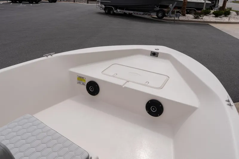 Slide: The Image of 2026 Carolina Skiff EV180 Sea Skiff interior view with storage compartment and speakers. - 12
