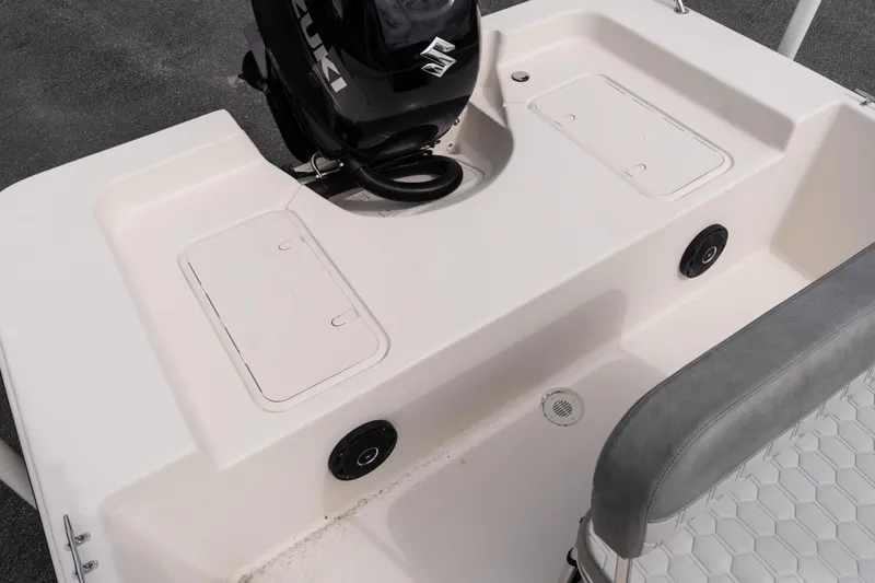 Slide: The Image of 2026 Carolina Skiff EV180 Sea Skiff boat interior with Suzuki engine and storage compartments. - 6