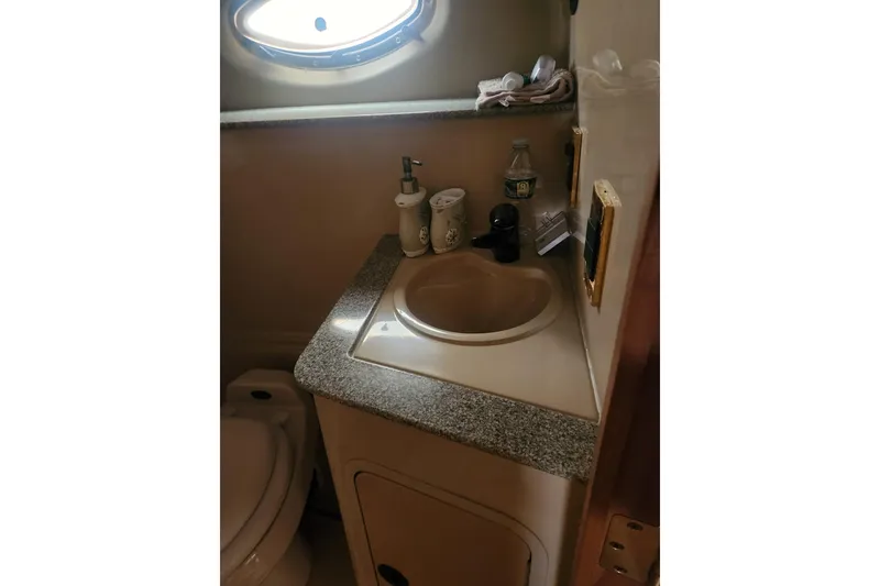 Slide: The Image of 2002 Cruisers Yachts 3870 Express bathroom with sink and toiletries. - 15
