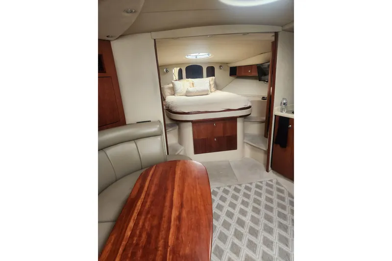 Slide: The Image of Luxurious interior of 2002 Cruisers Yachts 3870 Express with cozy bed and elegant wood finishes. - 5