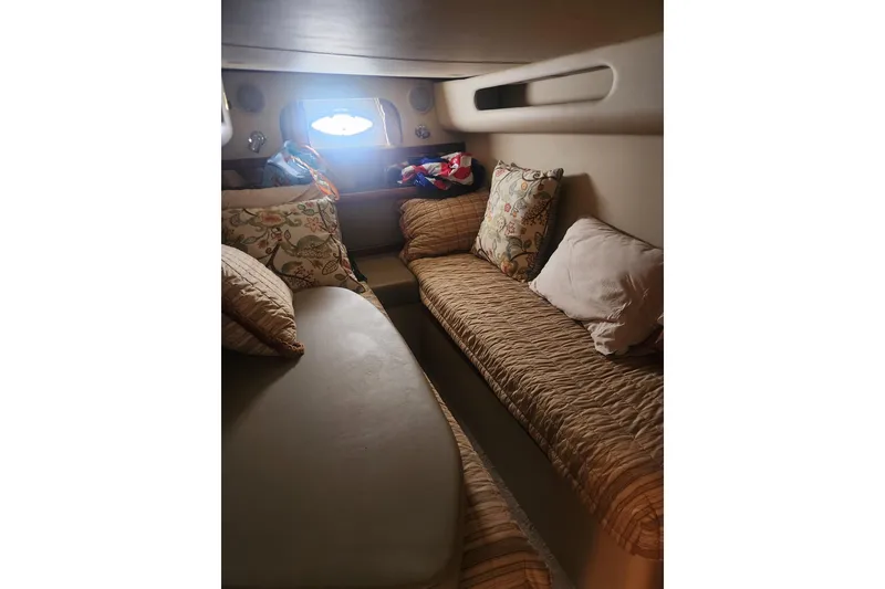 Slide: The Image of Interior cabin of 2002 Cruisers Yachts 3870 Express with cozy seating and pillows. - 14